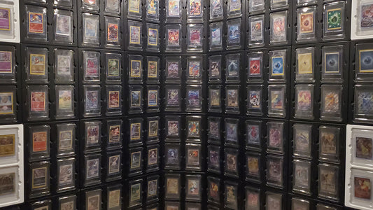 Pokemon collector joyfully displaying graded cards in Card Poppers Display.