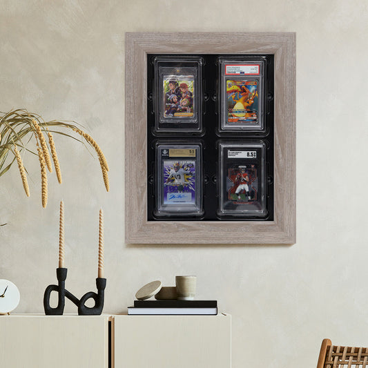 Card Poppers Weathered Oak 4 Trading Card Display" is mounted on a wall, containing an assortment of trading card slabs, including both graded and non-graded ones. The display has a rustic, aged oak appearance.