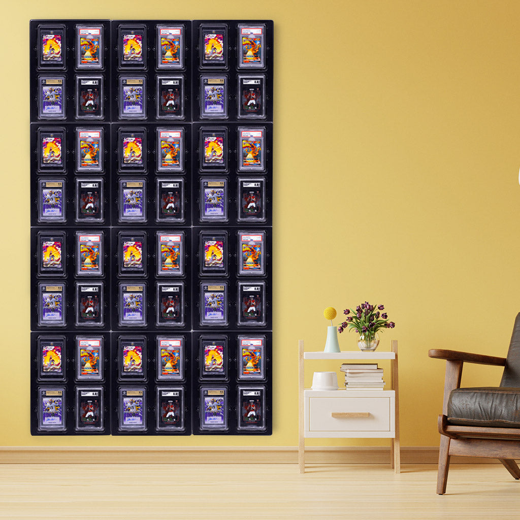 A residential living space showcasing a 48-card display. The display features 12 cards each in four different kinds of protective cases: PSA holders, magnetic card holders, SGC slabs, and Beckett-graded card cases. The arrangement of cards and holders provides variety and visual interest.