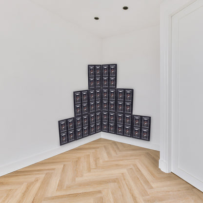 A pyramid-shaped display of 48 SGC-graded cards mounted on a corner wall of a room.